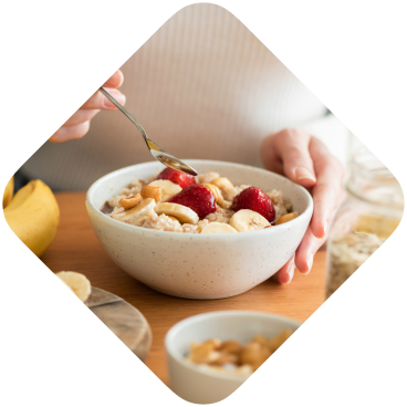Woman holding a bowl of oatmeal with fruit