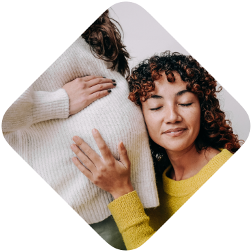 LGBT lesbian pregnant woman having tender moment listening her wife baby belly