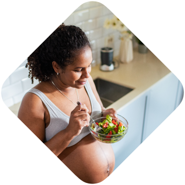 Preganant woman eating a salad