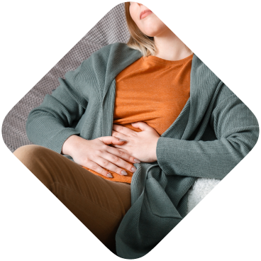 Adult woman lying on a couch, feeling unwell
